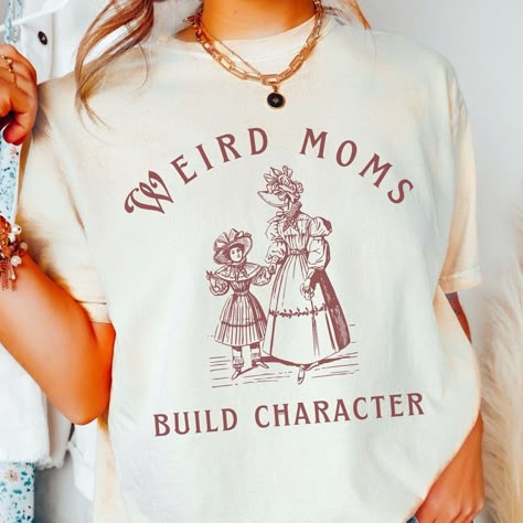 Weird Shirt Design, Weird Moms Build Character, Hippie Mom, Homeschool Shirts, Build Character, Mama Crewneck, Mom Graphic Tees, Crafty Mom, Funny Mom Shirt