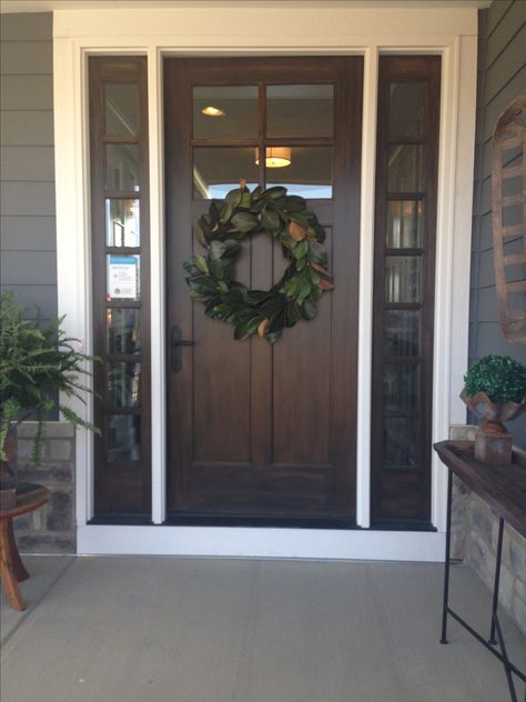 Front door on the farmhouse with magnolia wreath 3 Piece Front Door, Country Farmhouse Front Door, Shop House Front Doors, Dark Wood Front Door With Sidelights, Stain Front Door Wood, Front Doors With Top Window, Industrial Farmhouse Front Door, Gray House Brown Front Door, Wreath On Craftsman Front Door