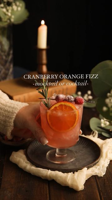 Ashley McCrary on Instagram: "✨CLICK HERE FOR RECIPE✨ 5-minute cranberry cocktail or mocktail perfect for the holidays. A combination of gin (or not), citrus juices, cranberry juice, bitters, and ginger beer. Garnished with dried orange, sugared cranberries, and a sprig of rosemary. The best! ✨MOCKTAIL✨ ▢2 oz cranberry juice ▢2 oz orange juice ▢0.5 oz lemon juice ▢2 oz ginger beer or ginger ale (ginger beer is non alcoholic) ▢2 tsp simple syrup or sugar-free simple syrup ✨COCKTAIL✨ ▢2 oz cranberry juice ▢1 oz orange juice ▢0.5 oz lemon juice ▢2 tsp simple syrup or sugar-free simple syrup ▢1 oz gin ▢2-3 dashes orange bitters ▢2 ounces of ginger beer #mocktails #mocktailsofinstagram #cocktails #holdiays #holidayrecipes #holidayseason #prettydrinks #cranberries #gin" Gin Ginger Ale Cocktails, Dried Orange Cocktail, Xmas Mocktails Non Alcoholic, Cranberry Orange Mocktail, Ginger Ale Mocktail Recipe, Mocktails Cranberry, Ginger Beer Mocktail Recipe, Ginger Mocktail, Christmas Mocktail