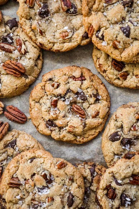 Brown Butter Pecan Chocolate Chip Cookies have a crispy-chewy texture, the irresistible crunch of pecans, and the rich sweetness of chocolate chips. Made with toasty brown butter for a touch of warmth, these cookies are topped with a sprinkle of flaky sea salt, elevating their flavor to new heights. Brown Butter Pecan White Chocolate Chunk Cookie, Carmel Pecan Chocolate Chip Cookie, Brown Butter Pecan White Chocolate Chunk, Chewy Oatmeal Pecan Cookies, Oatmeal Pecan Chocolate Chip Cookies, Cookie Recipes Pecan, Brown Butter Pecan Chocolate Chip Cookie, Chocolate Chip Molasses Cookies, Pioneer Woman Chocolate Toffee Crunch Cookies