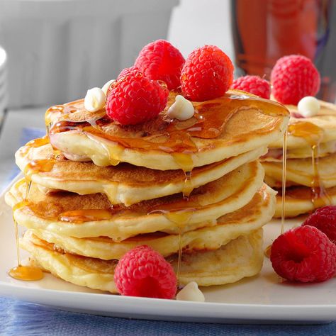 We grow berries in the summer, and I'm always looking for new ways to incorporate them into our meals. I created these white chocolate raspberry pancakes on a whim, and my husband thought they were great! Semisweet chocolate chips can easily be substituted for the white baking chips. —Sue Gronholz, Beaver Dam, Wisconsin White Chocolate Raspberry Pancakes, Raspberry Pancakes Recipe, White Chocolate Chip Pancakes, Grow Berries, Yeast Pancakes, Raspberry Pancakes, Baking Chips, Raspberry White Chocolate, White Chocolate Recipes