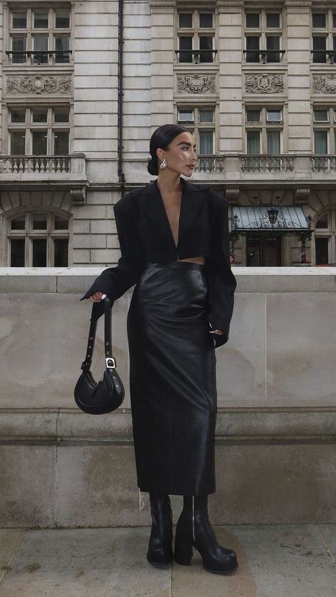 woman in black outfit, black bag, black heels, black boots, fall outfit