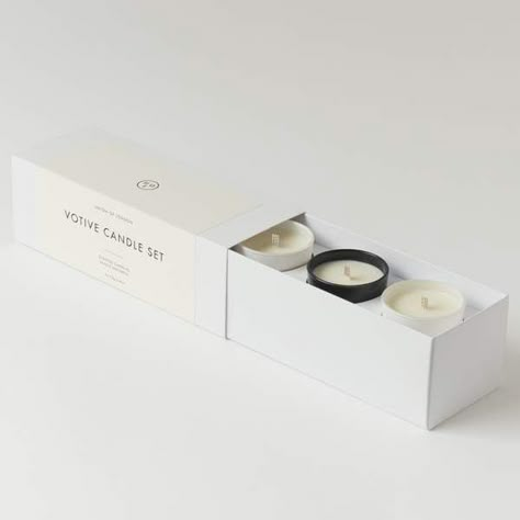 The beautifully packaged Votive Candle Set makes the perfect gift or a wonderful meditation aid. The high quality fragrances have a generous reach and the wide cotton wicks give the candles a clean burn. The set contains 1 Bless candle, 1 Fig and 1 Jasmine and Neroli. Candles: 3 x 75g, 2.6oz Box Size: H7cm x W8.5cmx x L22cm Weight: 570g, 20.1oz Burn Time: 54hrs (3 x 18hrs+) Material: Soy Wax Care: Keep wicks trimmed Votive: Gloss black and white glass Origin: UK Free from: Petroleum, Phthalates Luxury Candle Packaging Design, Candle Packaging Design, Candle Mockup, Shopify Business, Candles Photography, Small Business Packaging Ideas, Design Box, Candle Packaging, Candle Business