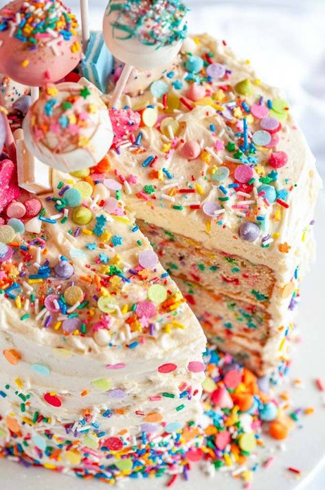 Birthday Surprise Confetti Cake - The ultimate festive birthday cake with a sprinkle explosion surprise inside! Made with a vanilla cake layer base and iced with cream cheese buttercream frosting. From aberdeenskitchen.com #birthday #surprise #confetti #cake #explosion #vanilla #sprinkles #funfetti #dessert #cakepops #buttercream #creamcheese #frosting Sprinkle Inside Cake, Birthday Cake With Sprinkles Inside, Birthday Cake Slice, Funfetti Cake Frosting, Funfetti Cake With Chocolate Frosting, Sprinkle Cake Decoration, Pink Confetti Cake, Funfetti Cake Decoration, Cake With Sprinkles