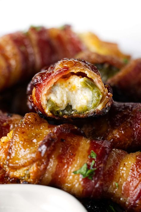 Traeger jalapeno poppers are the perfect party snack. They are stuffed with cheese, wrapped in bacon, and finished with a maple glaze. Stuffed Jalepeno, Bacon Wrapped Figs, Wrapped Jalapeno Poppers, Bacon Wrapped Jalapeno Poppers, Smoked Jalapeno, Bacon Wrapped Jalapenos, Pellet Smoker, Smoked Food, Wrapped In Bacon