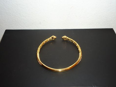 This listing is for a really beautiful 18K gold filled West Indian bangle. This bangle is designed with a beautiful intricate style carving and have arrow heads. It is adjustable and look great on the wrist. This bangle weigh 25.6g, is adjustable fits a 6-8 inch wrist.  Make this a great gift or treat yourself!! Buyer lands a great deal and will not be disappointed. Gold Kada Design, West Indian Bangles, Gold Kada, Gold Bangles Indian, Arrow Heads, Gold Bangles For Women, Bezel Bracelet, Wrist Jewelry, Bangles Design