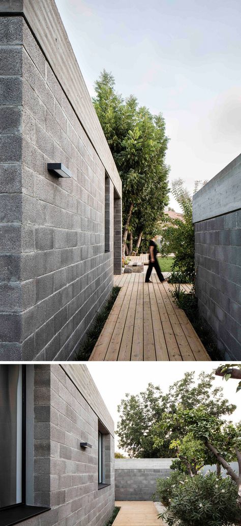 This modern house used raw concrete blocks and a concrete roof in its construction. Wood paths lead you around the house. Concrete Block House, Exterior Lighting Ideas, Concrete Masonry Unit, New Modern House, Wood Path, Concrete Block Walls, Block House, Industrial Home Design, Concrete Houses