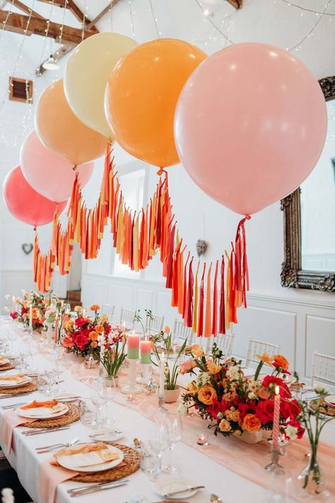 Merriscourt wedding with wedding tablescape with white wedding tablecloth, burlap place mats, tapered candles, pink and orange wedding stationery, and floral wedding table centrepieces with pink and orange garden roses, orange floribunda, yellow ranunculus flowers, foliage and Iceland poppies with red, pink orange and yellow balloons, wedding streamers and fairy lights | Sarah J Scott Photography Tasteful Party Decorations, Casual Event Decor, Event Party Decor, Colourful Event Decor, Colourful Party Theme, Balloon Tablescape, Bright Colour Birthday Theme, Colourful Birthday Decorations, Bright Coloured Wedding Decor