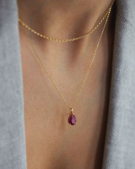 Embrace the timeless beauty of our 14K Solid Gold Ruby Pear Cut Necklace, a symphony of elegance and sophistication that transcends beyond the ordinary. This magnificent necklace contains a stunning pear-cut ruby, combined with an elegant 14K solid gold chain, creating a piece that is as unique as it is captivating. The pear-cut ruby compliments your style with timeless beauty. Its vibrant color and refined cut create a captivating sense that enchants every movement. Details: * 14K Solid Gold  * Raw Ruby Necklace, Gold Ruby Necklace, Ruby Jewelry Necklaces, Gold Minimalist Jewelry, Dainty Gold Jewelry, Accesories Jewelry, Ruby Necklace, Gold Diamond Necklace, Pendent Necklace