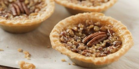 Mini Pecan Pies: 1 cup granulated sugar ½ cup corn syrup ½ cup maple syrup ⅓ cup (about 5 tbsp) salted butter, melted 3 Tbsp brown sugar 2 Tbsp whiskey ¾ tsp vanilla ½ tsp kosher salt 3 large eggs, beaten 1 heaping cup chopped pecans plus 14 whole pecans 14 prepared mini pie shells in disposable pans Pioneer Woman Pecan Pie, Mini Pecan Pie Recipes, Mini Pecan Pie, Pecan Pie Tarts, Maple Pecan Pie, Pecan Pie Bites, Food Network Recipes Pioneer Woman, Ree Drummond Recipes, Dessert Mini