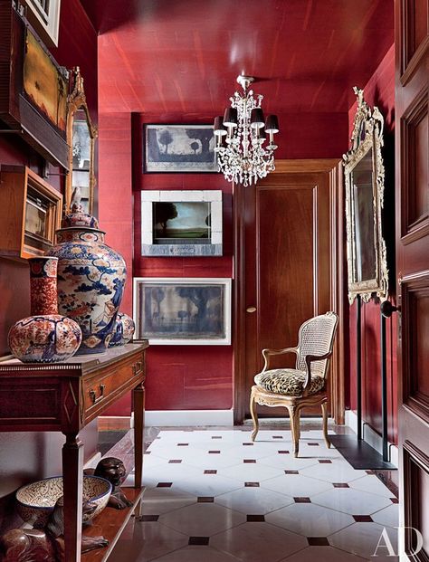 In the foyer of this Manhattan apartment decorated by John Yunis Ltd., paintings by Alexander Mihaylovich are interspersed with antique mirrors | archdigest.com Lacquered Walls, Manhattan Apartment, Red Rooms, Red Walls, Decoration Inspiration, The Ceiling, Red Interiors, Annie Sloan, Color Of The Year