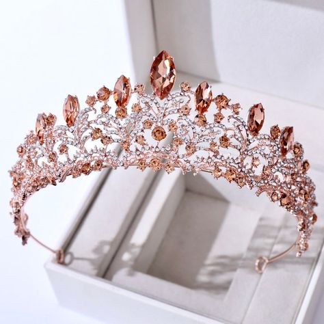 Inspired by the old days of royalty when times were filled with extravagant parties and lavish luxuries, this unique tiara conveys a modern take on old elegance and grand entrances. Adorned with intricately faceted crystals that work their way across the band in a swirly pattern and capturing the light from every angle with a perfectly translucent appeal, this exquisite tiara can complete the most sophisticated of bridal looks. Cast in lightweight alloy and rose gold / silver / yellow gold plate Veil Tiara, Wedding Hairstyles With Crown, Headband Wedding Hair, Quinceanera Crown, Bridal Tiaras, Tiara Headband, Crystal Bridal Tiaras, Beautiful Tiaras, Tiara Wedding