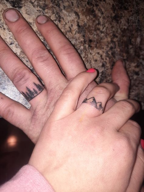 Couple tattoo, finger tattoo, mountain tattoo, tree tattoo, outdoorsy tattoo Hidden Matching Couple Tattoos, Couples Simple Tattoos, Cute Western Couple Tattoos, Matching Tat Couple, Finger Tattoos Couples, Outdoorsy Tattoos Matching, Matching Couple Finger Tattoos, Western Couple Tattoo Ideas, Corresponding Tattoos Couples