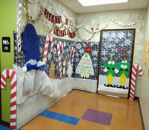 Decorated school door with Elf movie theme. Classroom Christmas Photo Booth, Elf Desk Decorations, Buddy The Elf Narwhal, Elf The Movie Office Decorating Ideas, Elf Cubicle Christmas Decorations, Elf Christmas Office Decorations, Elf Movie Bulletin Board, The Movie Elf Decorations, Buddy The Elf Themed Christmas Classroom Decor