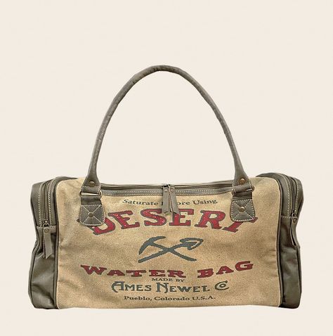 "Desert Waterbag Duffle/Travel Bag American Glory are meticulously handcrafted Handbags & Accessories, inspired by history... vintage posters, advertisements and burlap sack designs are nostalgic and gives a connection to America's past. Travel in style... this travel bags artwork replicates a Desert Water Bag, between the 1920s to the 1960s bag was filled with water, hung on the outside of cars and ready to douse the radiator if it overheated, or quench the thirst of the driver. Before you set off on your own adventures remove straps to carry bag by the leather handles, or keep them on to sling it across your shoulder as a cross-body. Plenty of room inside this bag for all of your clothes along with 2 large external pockets, zippered back pocket to quickly go in and out of and 3 more inte 70s Duffle Bag, Vintage Duffel Bag, Vintage Travel Bag, Vintage Duffle Bag, Duffle Bag Aesthetic, Cute Duffle Bag, Cool Luggage, Handcrafted Handbags, Canvas Bag Design