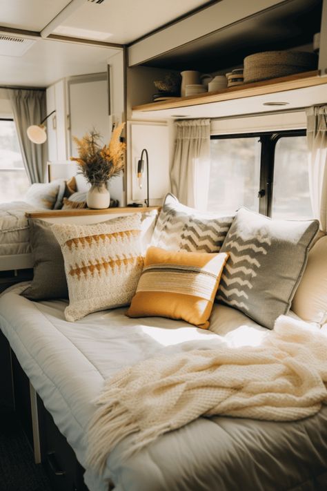 Upgrade your motorhome or camper's bedroom with these inspiring ideas. Small spaces can be challenging, but with the right design elements, you can create a functional and attractive sleeping area. Discover how to make your RV's bedroom pop with decorative accents and clever storage solutions. Transform your space into a cozy retreat on the road! Motorhome Bedding, Camper Master Bed Remodel, Cozy Rv Bed, Rv Bed With Window, Cute Camper Bedding, Camper Bedding, Rv Bedroom Ideas, Camper Decorations, Rv Bedding