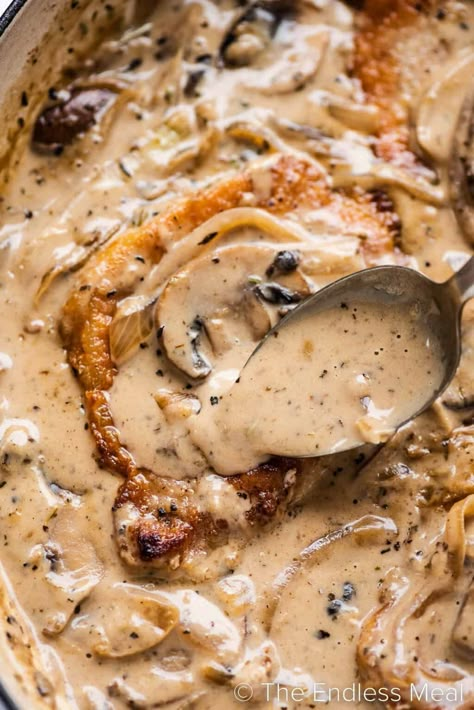 Tender smothered pork chops are pan-seared to golden perfection and then served in a savory onion and mushroom gravy. Not only is this one of our favorite ways to prepare pork chops, but it's also a quick and easy recipe for weeknights. Ready in just 25 minutes! #theendlessmeal #porkchops #smotheredporkchops #porkchopsmushrooms #porkchoprecipe White Gravy For Pork Chops, Mushroom Gravy Pork Chops, Cream Of Mushroom Pork Chops, Onion And Mushroom Gravy, Panko Pork Chops, Mushroom Onion Gravy, Cheesy Pork Chops, Pork Chop Dishes, Oven Pork Chops