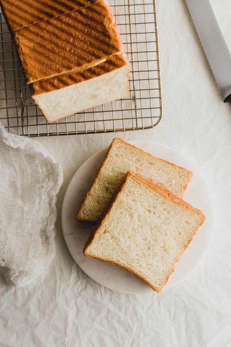 Slices of Japanese shokupan on white round marble and wire rack. Shokupan Bread, Bread Photography, Asian Side Dishes, Japanese Milk Bread, Milk Bread Recipe, Japanese Bread, Dessert Tea, Swirled Bread, Milk Bread