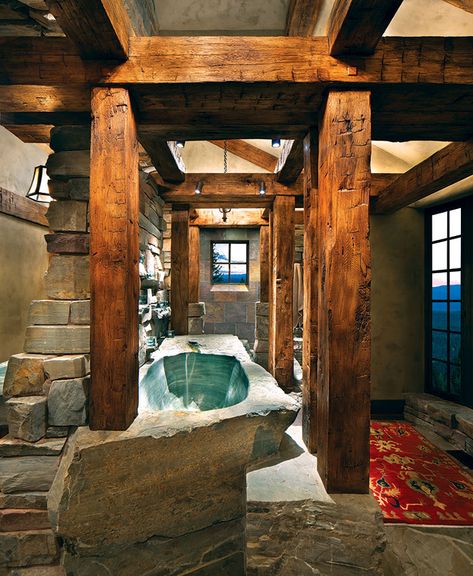 The 10-foot, 12,000-pound stone bathtub was hand-carved by Sean Henry and Jonathan Kersey of Rock & Water International. White oak beams were hand-hewn by contractor Walt Landi and his son Luke. Rustic Bathrooms Ideas, Castle Bathroom, Diy Rustic Bathroom, Country Builders, Rustic Log Cabin, Rustic Bathroom Designs, Mountain Living, Rustic Bathrooms, Dream Bathrooms