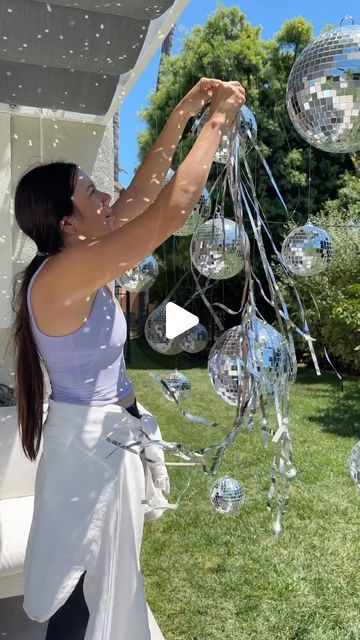 Deborah Trette on Instagram: "disco ball party backdrop —  This night is sparkling, don’t you let it go ✨🪩 put together a mini party for the girls and this set-up came out so so cute!  I recommend for an evening celebration!💫  hang disco balls in different sizes with fishing line, tie tinsel and crepe paper.   #diyparty #diypartyideas #partydecorations #easypartyideas #partybackdrop #taylorswift #taylorswiftpartyideas #discoballdecor #discoball #diy #amazonfinds" Disco Balls In Pool, Diy Disco Ball Chandelier, Disco Party Backdrop, Diy Disco Ball, Disco Ball Party, Disco Birthday Party, Disco Night, Taylor Swift Party, Ball Party