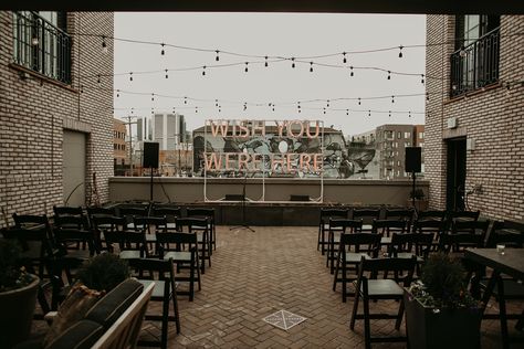 Rooftop Ceremony with Lighted Sign and String Lights Wedding Sayings For Signs, Ramble Hotel, Deep Color Palette, Wedding Quote Signs, Industrial Reception, Modern Outdoor Lounge Furniture, Wedding Sayings, Sayings For Signs, Rooftop Ceremony