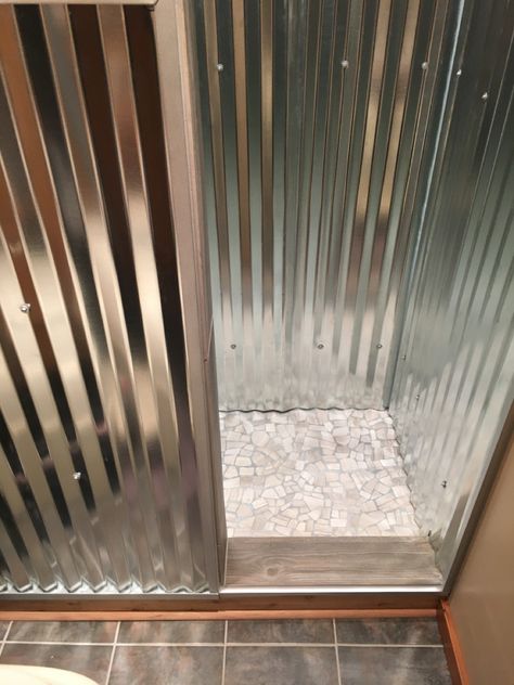 Corrigated stainless steel rustic off-grid cabin and copper shower head tiled transition Stainless Steel Shower Walls, Tin Shower Walls, Galvanized Shower, Plumbing A Bathroom, Tin Shower, Copper Shower Head, House Basement, Outdoor Shower Diy, Panic Rooms