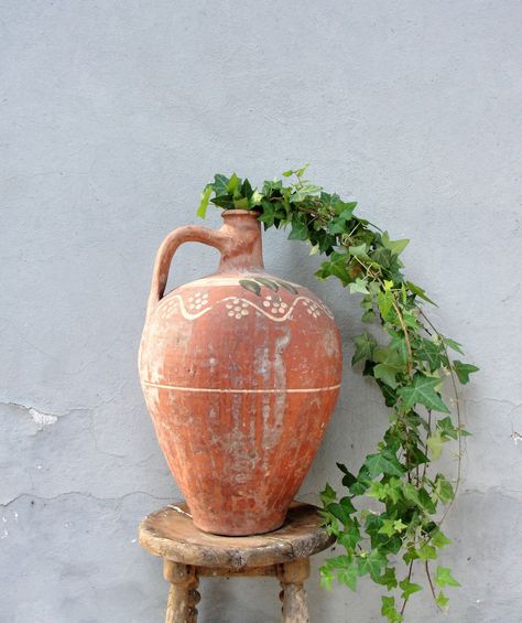 This gorgeously rustic clay pot would look great in your home, garden, balcony or porch during any season. It is handmade out of clay and has these beautiful color textures only time can make and everything is still strong. There are no tears, cracks or holes. It is entirely handmade, the handle is strong but I carry it by holding to it on its body just to be sure. This is an incredible unique and rare piece. I can totally imagine this in your home with a plant, or dried flowers, or a bunch of ( Large Pottery, Driftwood Branch, Garden Balcony, Elephant Decor, Pottery Planters, Large Planters, Clay Pot, Planter Pots Indoor, Pottery Pieces