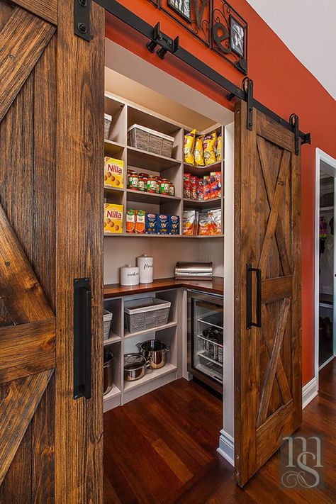 By utilizing the closet space in the adjoining home office, we were able to create a walk-in pantry accessed through the nook. Rustica weathered barn doors hide the large walk-in pantry housing more Subzero wine and beverage refrigeration. Log Cabin Pantry, Log Cabin Walk In Closet, Walk In Pantry With Barn Door, Pantry With Island Walk In, Western Pantry Ideas, Country Pantry Ideas, Barndominium Pantry Ideas, Shop House Living Room, Rustic Walk In Pantry