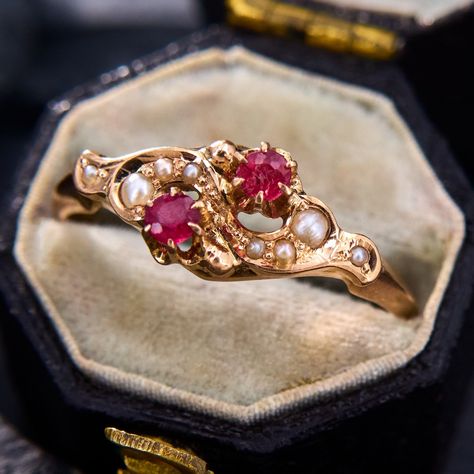 This sweet antique ring is crafted in 10k rose gold and is set with round red colored garnet and glass doublets in an open swirl of gold accented with seed pearls.  It is currently a size 7.5.  One of the doublets is chipped but this is difficult to notice while worn. Vintage Rings Pearl, Antique Ruby Earrings, Vintage Gemstone Ring, Ruby And Gold Ring, Gold Vintage Wedding Rings, Vintage Rings Antiques, Red Wedding Rings, Georgian Engagement Ring, 5 Golden Rings