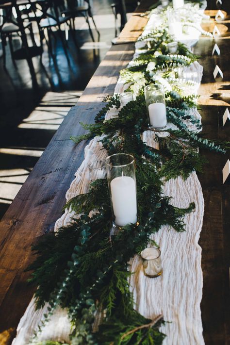 Simple greenery, candles, gold accents, head table, muslin table runner Muslin Table Runner, Muslin Table Runner Wedding, Black Table Cloth With White Runner, Wedding Table Decor Simple, Candle Theme Wedding, White And Green Table Runner Wedding, Foliage Wedding Table Runner, Greenery Table Runner With Fairy Lights, Lush Greenery Table Runner