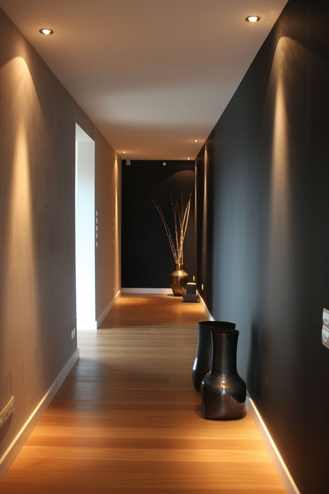 Contemporary hallway with a black accent wall and minimalist decor Modern Home Hallway, Dramatic Foyer Entrance, Dark Modern Hallway, Hallway Ideas Black, Black Walls Hallway, Hallway Wall Ideas, Grey Hallway Ideas, Grey Hallway, Home Hallway