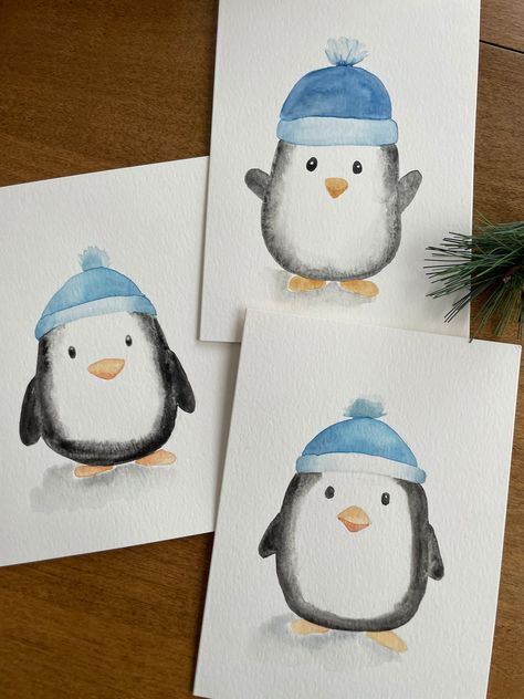 Description: Bring a touch of charm to your holiday greetings with this adorable winter penguin watercolor card! This 5x7 card features a hand-painted watercolor illustration of a cute penguin wearing a cozy blue hat, making it perfect for spreading warmth and joy during the holidays. Key Features: ❄️Original Watercolor Art: Each card showcases a unique, hand-painted winter penguin, ensuring that no two cards are exactly alike. ❄️Perfect for the Holidays: Ideal for Christmas, winter celebrations, or any festive occasion. ❄️Blank Inside: Plenty of space for your personalized message, making it suitable for various occasions. ❄️Quality Materials: Made with premium Strathmore watercolor paper for a beautiful and lasting finish. ❄️ White Envelope Included: Comes with a high-quality white envel Christmas Card Designs Watercolour, Easy Holiday Watercolor, Winter Cards For Kids, Winter Painting Watercolor, Cute Watercolor Christmas Cards, Watercolor Winter Art, Watercolor Paintings Christmas Cards, Christmas Cards To Paint, Christmas Painting Watercolor