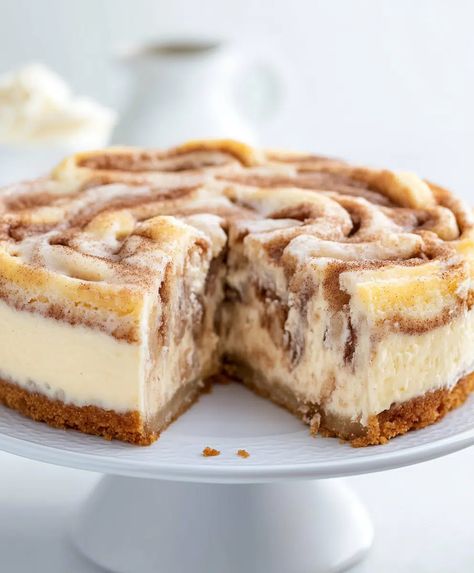 Cinnamon Roll Cheesecake Recipe - sandyrecipes.com Cheesecake Factory Cinnabon Recipe Copycat, No Bake Cinnamon Cheesecake, Cinnamon Bun Cheesecake Recipe, Cinnamon Cheesecake Bars, Cinnamon Roll Cheesecake Recipes, Croissant Cheesecake, Cinnamon Bun Cheesecake, Popular Cheesecake Recipes, Cinnamon Roll Desserts