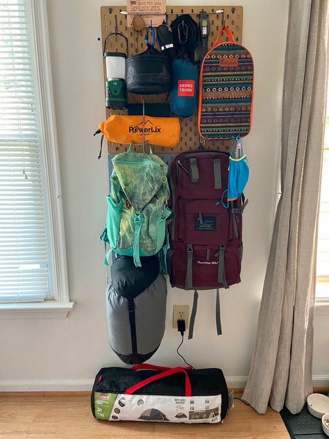 Camping and hiking  gear storage using pegboards. Camp Gear Storage Ideas, Backpacking Storage Ideas, Pegboard Camping Gear Storage, Camping Gear Pegboard, Hiking Gear Closet, Adventure Office Decor, Pegboard Gear Wall, Outdoor Gear Storage Apartment, Hiking Gear Peg Board