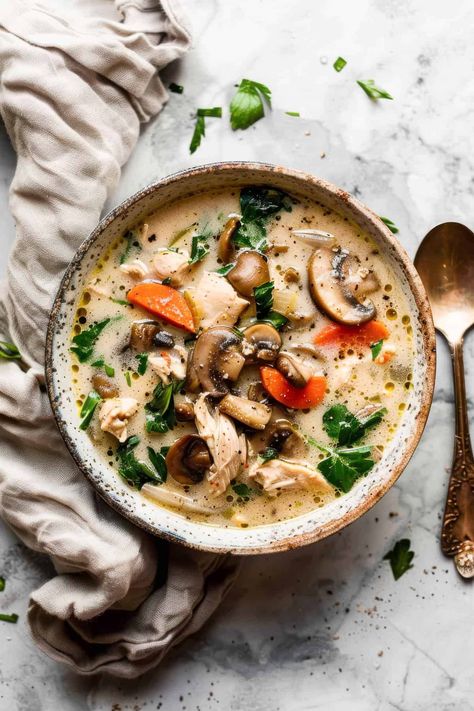 Creamy Chicken and Mushroom Soup - So cosy, so comforting and just so creamy. Best of all, this is made in the slow cooker (crockpot) - so quick and easy! This healthy but still creamy soup is packed with browned butter mushrooms and vegetables. It's the perfect way to stretch your budget and get a restaurant-worthy meal for cheap! All ingredients are from Aldi. Creamy soup, budget recipe. Mushroom Thyme Soup, Slow Cooker Chicken Mushroom Soup, Mushroom Soup Slow Cooker, Creamy Chicken And Mushroom Soup, Light Mushroom Soup, Kale Mushroom Soup, Rotisserie Chicken Mushroom Soup, Mushroom Soup Recipes Crockpot, Soup With Mushrooms In It