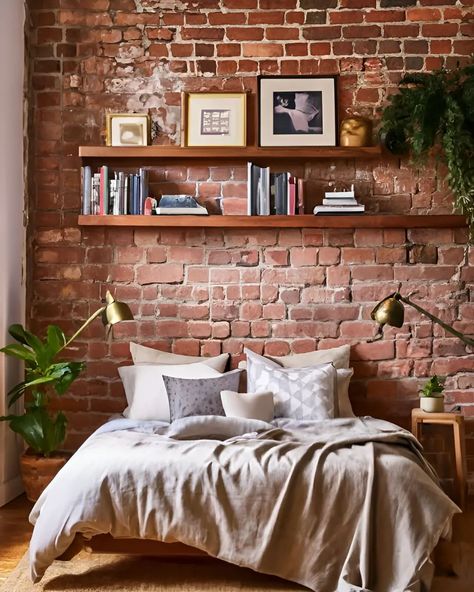 Cozy and stylish bedroom vibes! Loving the exposed brick wall and the warm, inviting decor. Perfect for relaxing with a good book. #BedroomGoals #CozyHome #InteriorDesign #ExposedBrick" Red Brick Bedroom Wall, Exposed Brick Apartment Living Room, Bricks Bedroom Ideas, Exposed Brick Room, Exposed Brick Studio Apartment, Bedroom With Exposed Brick, Exposed Brick Apartment Aesthetic, Brick Wall Room Ideas, Floating Shelves On Brick Wall