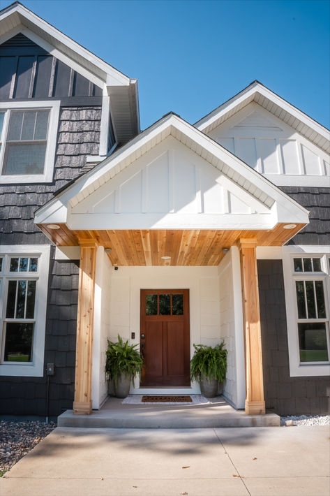 Transform your entryway with the timeless beauty of cedar accents! 🌿✨ Cedar adds warmth, character, and a natural touch to any home exterior, making it the perfect finishing touch for your design. Whether you're updating your home or starting from scratch, cedar accents will elevate your curb appeal instantly!  #CedarAccents #HomeExterior #CurbAppeal #NaturalWood #HomeDesign #ExteriorMakeover Dark Gray House With Cedar Accents, Cedar Home Exterior, Gray House With Cedar Accents, Cedar Accents On House Exterior, Cedar Front Porch, White Siding House, Dark Grey Houses, Cedar Shutters, White Siding