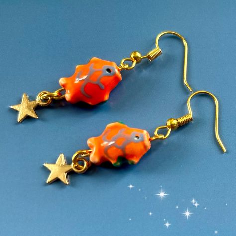 Japanese painted bead gold  koi fish earrings. Unique to my shop! Cute mini ceramic bead koi fish carp star earrings. The koi fish has long been known as a lucky symbol of good fortune.  These earrings feature a unique design that is my own design making them a one-of-a-kind gift for your loved ones. The cute ceramic fish on the earrings are seen swimming upstream against the current, symbolizing perseverance and strength.  Measuring at 1.5cm x 1 cm the charm size is perfect for making a splash Cute Japanese Accessories, Clay Fish Earrings, Gold Koi Fish, Gold Koi, Funky Accessories, Zen Gifts, Fish Symbol, Cool Earrings, Family Peace