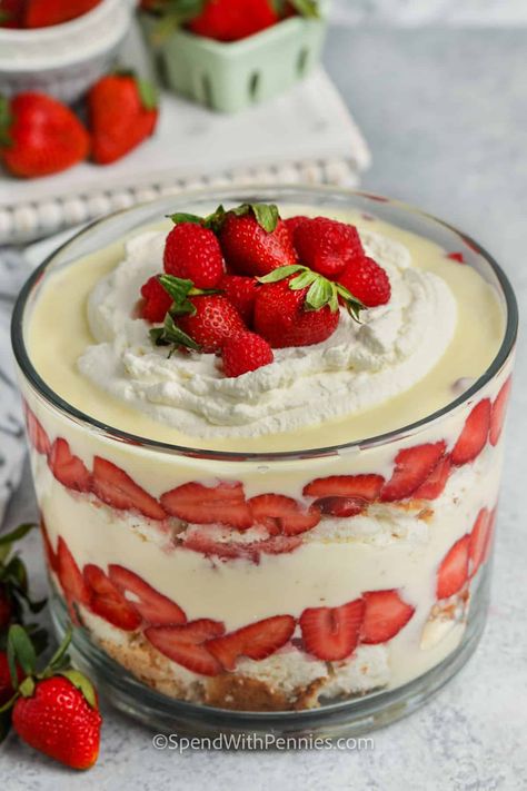 A layered trifle is so easy to make. Guests will gush over the impressive presentation of this fresh & fruity dessert. Sweet white cake, custard or vanilla pudding, and strawberries topped off with whipped cream. It's a summer favorite! #trifle #triflerecipe #easytrifle #spendwithpennies Cream Cheese Strawberry Shortcake, Fruit Trifle Recipes Custard, Strawberry Shortcake With Vanilla Pudding, Strawberry Trifle With Pudding, Trifle With Vanilla Wafers, Strawberries And Cream Trifle, Vanilla Cake Trifle, Strawberry Shortcake Trifle Easy, Truffle Desserts Layered Easy