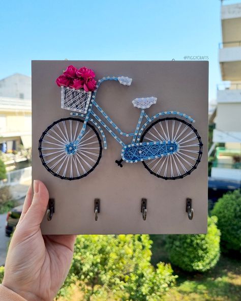 "Bicycle String Art Key Holder by Piggy Crafts This cute bicycle is the perfect reminder to never forget your keys again! It will also give an organized and vintage look to your entryway! This key holder is the perfect addition to any home. Hang it on your wall or offer it as a housewarming gift. Handcrafted on a sand-beige melamine-faced chipboard. Four hooks are secured to the front to easily hang your keys. It comes with 2 picture hangers attached to the back. Please remember that colors may Bicycle String Art, String Art Patterns Free, فن الرسم بالمسامير, Diy Crafts Love, Antique Wall Decor, Shapes And Patterns, String Wall Art, String Crafts, Easy Face Mask Diy