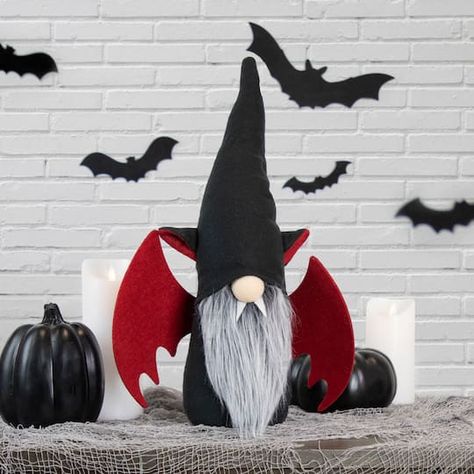 "Find the 18\" Male Black & Red Halloween Gnome with Bat Wings at Michaels. com. Decorate your mantles and table tops this Halloween with this devilish gnome. Decorate your mantles and table tops this Halloween with this devilish gnome. The bright red wings will add the perfect pop of color to your Halloween décor. The pointy black hat will pair well with witch and spider decorations. White fangs accent the bulbous nose. Pointy and bendable black hat covers the eyes. Red and black ears are attac Black Red Halloween, Décoration Table Halloween, Bulbous Nose, Red Halloween, Spider Decorations, Halloween Figures, Girl Gnome, Halloween Gnome, Halloween Table Decorations