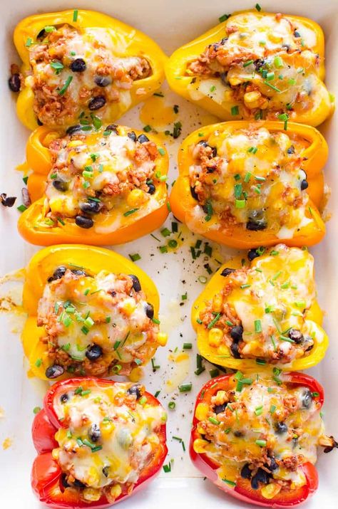 Mexican Stuffed Peppers with flavorful ground turkey, rice, corn and black beans baked inside colorful bell peppers with melted cheese on top. So delicious and easy! You need to make these! Stuffed Bell Peppers Turkey, Ground Turkey Rice, Corn And Black Beans, Beans Baked, Ground Turkey Stuffed Peppers, Baked Peppers, Mexican Stuffed Peppers, Turkey Rice, Stuffed Peppers Turkey