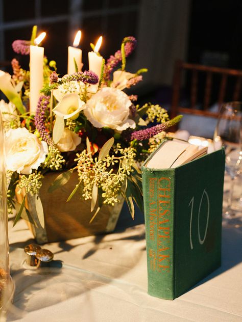 Embrace your inner bookworm with these 14 creative ways to use books as wedding decor. Book Themed Wedding Decorations, Book Table Numbers Wedding, Book Wedding Centerpieces, Book Lovers Wedding, Book Table Numbers, Elvish Wedding, Rapunzel Wedding, Book Centerpieces, Book Themed Wedding