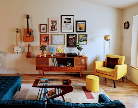 Mid Century Modern Living Room Gallery Wall, Gallery Wall Over Sectional, Retro Mid Century Modern Living Room, Gallery Wall With Instruments, Hang Instruments On Wall, Accent Gallery Wall Ideas, Living Room With Instruments, Apartment Accent Chairs, Hanging Instruments On Wall