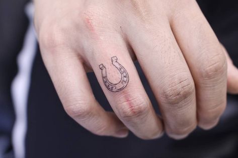 Little horseshoe tattoo on the right hand’s ring finger Tiny Horseshoe Tattoo, Shoe Tattoo, Horseshoe Tattoo, Hand Tattoo Images, Luck Tattoo, Horse Shoe Tattoo, Cowgirl Tattoos, Shoe Tattoos, Small Finger Tattoos