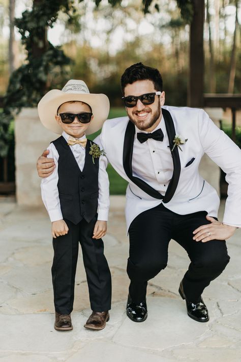 | groom + ring bearer photo ideas | wedding photos with sunglasses | fun wedding photo ideas | cowboy ring bearer | southern wedding ideas | ring bearer in a peach bow tie | wedding style ideas | wedding photo inspiration | photo taken at THE SPRINGS Event Venue. follow this pin to our website for more information, or to book your free tour! SPRINGS location:  Stonebridge in Magnolia, TX photographer:  Kristen Curette Photography #ringbearer #groom #weddingstyle #weddingphotos #weddingideas #hou Western Ring Bearer Outfit, Photos With Sunglasses, Fun Wedding Photo Ideas, Cowboy Ring, Southern Wedding Ideas, Wedding Style Ideas, Peach Bow Tie, Ideas Wedding Photos, Groom Ring