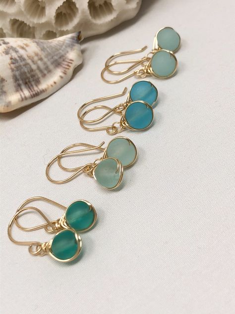 A minimal yet luxurious design featuring beautiful, cultured sea glass. These colors are so gorgeous and translucent they look like they glow from within! These cultured sea glass beads are 6mm in size Each shade of blue is reminiscent of the crystal blue waters in exotic regions of the world. The design is kept subtle with a dainty herringbone wrap and a finished with a hand-forged French ear wire. #christmasgiftideas #christmasgiftforher #giftsforher Foam Earrings, Wire Jewelry Rings, Sea Glass Beads, Beachglass Jewelry, Sea Glass Earrings, Diy Wire Jewelry, Wrap Jewelry, Wire Work Jewelry, Jewellery Ideas