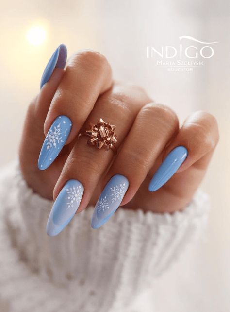 Find inspiration for 55 beautiful blue winter nail designs from solid to ombre to glitter styles perfect for the cold season. Get ideas for French tips with blue, royal, and navy polish, snowflake nail art, and swirling or marbled looks that capture the icy essence of winter. #winter #winterstyle #wintermanicure #bluenails #winternails #lightbluenails $royalbluenails #darkbluenails #navybluenails French Tips With Blue, Blue Winter Nail Designs, Blue Winter Nails, Snowflake Nail, Light Blue Nails, Snowflake Nail Art, Winter Manicure, September Nails, Indigo Nails