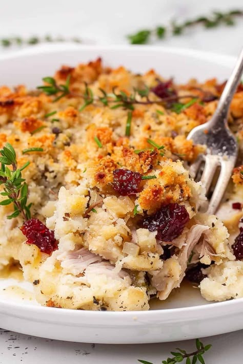 Close-up of a serving of leftover turkey casserole with a golden breadcrumb topping and garnished with dried cranberries and fresh herbs. Turkey Stuffing Cranberry Casserole, Leftover Turkey And Stuffing Casserole Thanksgiving Leftovers, Christmas Turkey Casserole, Turkey Cranberry Casserole, Leftover Turkey Wraps, Recipe Using Leftover Stuffing, Leftover Thanksgiving Turkey Ideas, Turkey Recipes Thanksgiving Leftovers, Dressing And Turkey Casserole