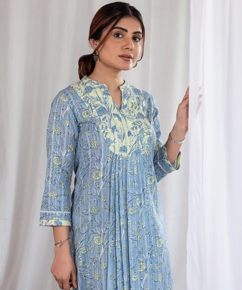 Summer Collection - New Arrivals! Wrap yourself in a soft, pastel embrace of powder blue and pale yellow with our ‘Carnation Yoke Kurta’. Gentle pleats mimic the ruffled petals of the ‘Chandani’ flower while the yoke and sleeves are highlighted with fine gudri work and contrast ladder lace details. [ Cottons Jaipur, Cotton, Carnations, Floral, Handmade Kurtas, Everyday-wear, Summer staples ] #cottons #cottonsjaipur #newarrivals #floral #summer #summer2024 #handcraftedkurtas #comfortfits #... Cotton Suits With Laces, Suit Sleeves Design, Cottons Jaipur, Unique Tops, Indian Suits For Women, Neck Patterns, Salwar Pattern, Dress Models, India Dress